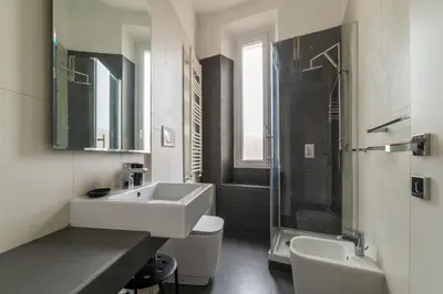a bathroom with a sink and a toilet and a shower at GuestHost - Trastevere Station Bright Apartment with Terrace in Rome