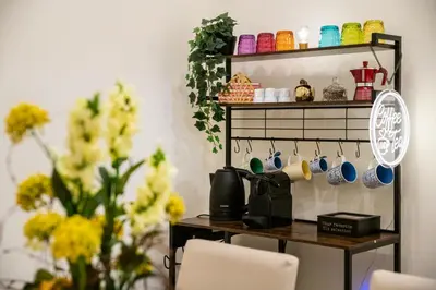 a shelf with a mirror and a table with flowers at Stella Luxury House - Lombardia in Rome
