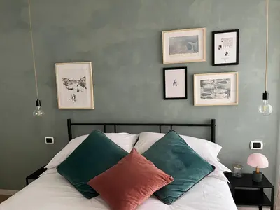 a bedroom with a bed with four pictures on the wall at Urban Corner in Rome
