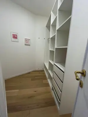 a closet with white shelves and a door at Urban Corner in Rome