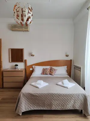 a bedroom with a bed with two towels on it at Guest House Rome Termini Station in Rome