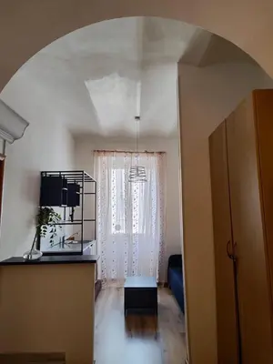 a living room with an arched ceiling and a room with a window at Guest House Rome Termini Station in Rome