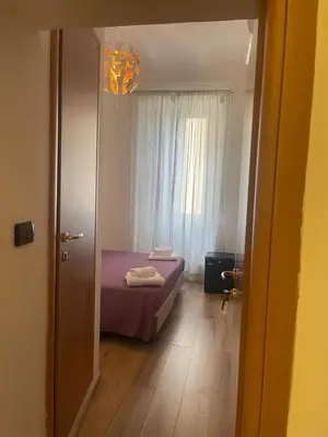 a bedroom with a purple bed and a window at Guest House Rome Termini Station in Rome