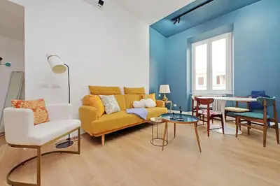 a living room with a yellow couch and chairs at Scipioni2 in Rome