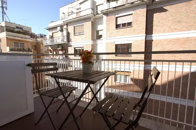 a table and two chairs on a balcony at Vigna Clara 2BR Holiday House in Rome
