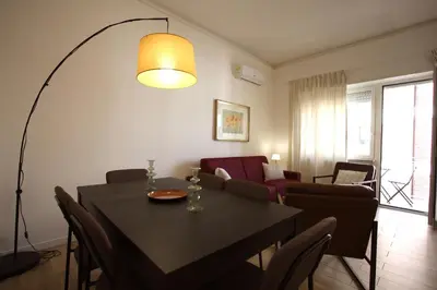 a living room with a dining room table and a living room at Vigna Clara 2BR Holiday House in Rome