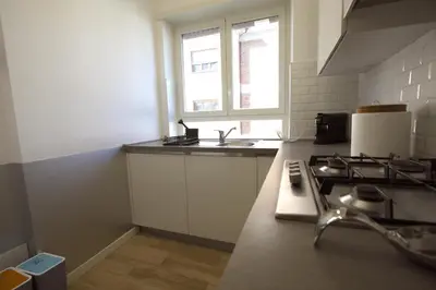 a kitchen with a sink and a stove in it at Vigna Clara 2BR Holiday House in Rome