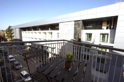 a balcony with a bench and a building at Vigna Clara 2BR Holiday House in Rome