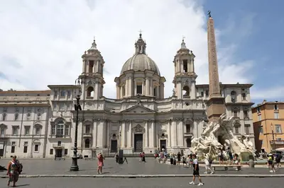 a large building with a statue in front of it at Piazza Navona in Rome