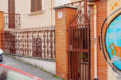 an iron gate on the side of a building at Casa Cesari in Rome