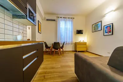 a kitchen and living room with a table and chairs at Casa Cesari in Rome