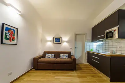 a living room with a couch in a kitchen at Casa Cesari in Rome