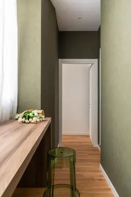 a room with a counter and a stool and a door at Casa Dante in Rome