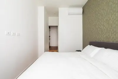 a bedroom with a large bed with white sheets at Casa Dante in Rome