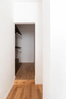 an empty room with white walls and a wooden floor at Casa Dante in Rome