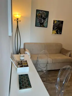 a living room with a couch and a table at Sweet Home Acaia - San Giovanni in Rome