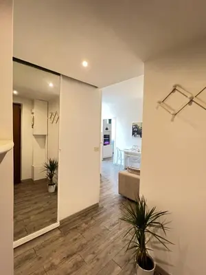 a living room with a hallway with plants in it at Sweet Home Acaia - San Giovanni in Rome