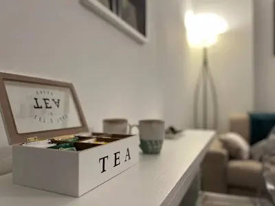 a box of tea sitting on a table in a living room at Sweet Home Acaia - San Giovanni in Rome