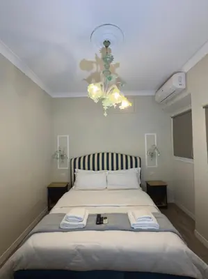 a bedroom with a bed and a chandelier at Rome Piazza di Spagna Guesthouse in Rome