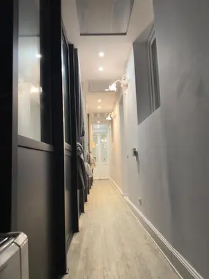 a hallway with a long line of doors and a hallwayngth at Rome Piazza di Spagna Guesthouse in Rome