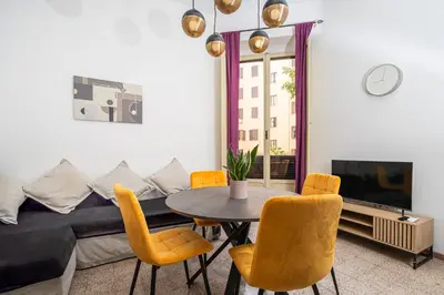 a living room with a table and chairs and a bed at Mazzini 38 in Rome