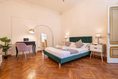 a bedroom with a bed and a desk and a table at Mazzini 38 in Rome