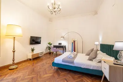 a bedroom with a bed and a desk and a mirror at Mazzini 38 in Rome
