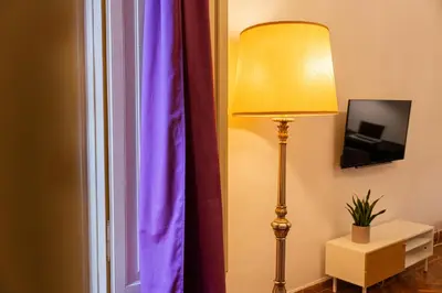 a lamp next to a window with a purple curtain at Mazzini 38 in Rome