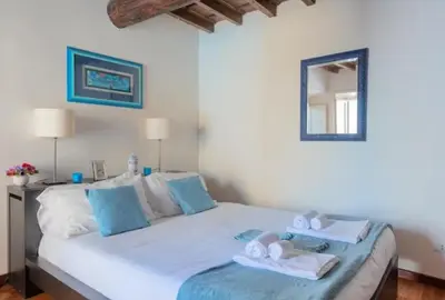 a bedroom with a large bed with towels on it at Roman heritage- Pantheon- up to 6 guests in Rome