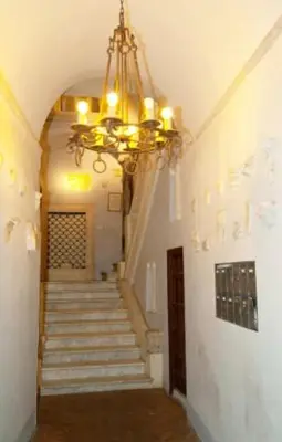 a hallway with a chandelier and stairs in a building at Roman heritage- Pantheon- up to 6 guests in Rome