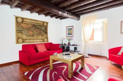 a living room with red couches and a table at Roman heritage- Pantheon- up to 6 guests in Rome
