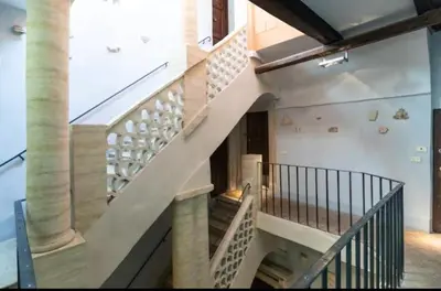 a spiral staircase in a building with columns at Roman heritage- Pantheon- up to 6 guests in Rome