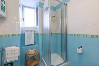 a bathroom with a shower with a glass door at Roman heritage- Pantheon- up to 6 guests in Rome