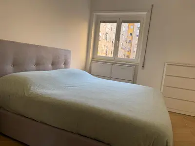 a bedroom with a large bed with a window at Casal Sweet Home in Rome