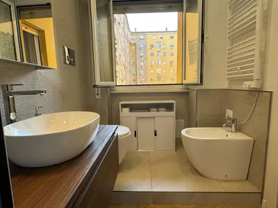a bathroom with a large white tub and a sink at Casal Sweet Home in Rome