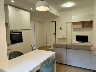 a kitchen and living room with a couch and a table at Casal Sweet Home in Rome