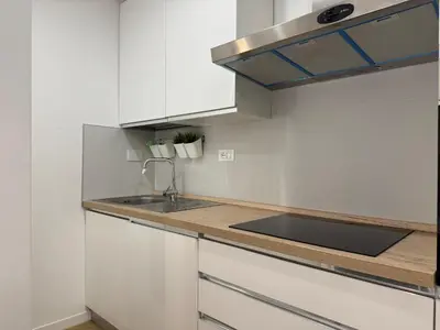 a kitchen with white cabinets and a sink at Casal Sweet Home in Rome