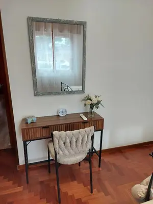 a wooden desk with a mirror and a chair at Loft Tranquillo e Comodo, Vicino Metro e Vaticano in Rome