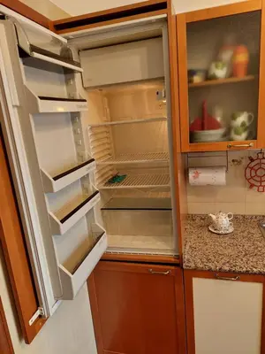 an empty refrigerator with its door open in a kitchen at Loft Tranquillo e Comodo, Vicino Metro e Vaticano in Rome