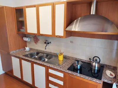 a kitchen with a sink and a stove at Loft Tranquillo e Comodo, Vicino Metro e Vaticano in Rome