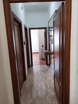 a hallway with a door and a room with a table at Loft Tranquillo e Comodo, Vicino Metro e Vaticano in Rome