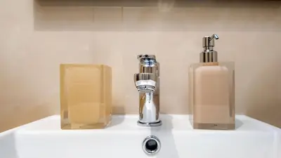 a bathroom sink with two bottles of soap on it at Aura Vatican Suite in Rome