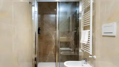 a bathroom with a shower and a sink and a toilet at Aura Vatican Suite in Rome