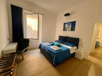 a bedroom with a bed and a chair and a window at Trastevere ON in Rome