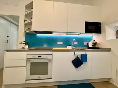 a kitchen with white cabinets and a sink at Trastevere ON in Rome