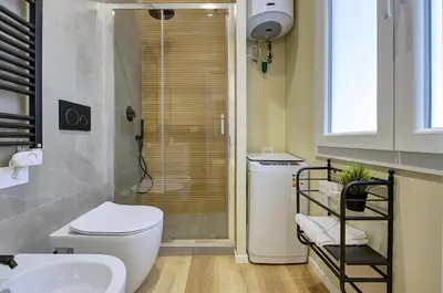 a bathroom with a toilet and a sink and a shower at Silver Loft San Giovanni in Rome