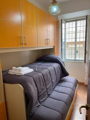 a bed with a blue couch in a room at Rachel house in Rome