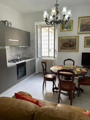 a kitchen and dining room with a table and chairs at Rachel house in Rome
