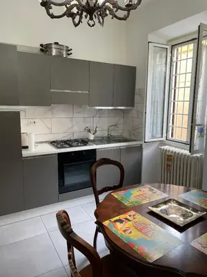a kitchen with a table and a stove and a sink at Rachel house in Rome
