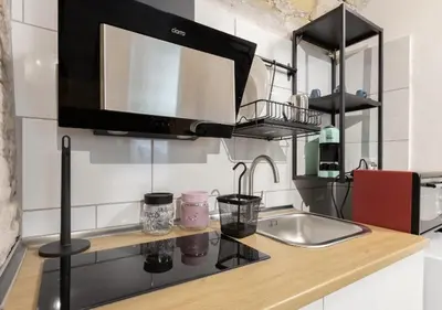 a kitchen with a sink and a microwave at Paradise Vatican Home in Rome